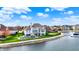 Beautiful waterfront home featuring a pool, deck, and lush green lawn with mature landscaping at 4883 Snowberry Bay Ct, Carmel, IN 46033