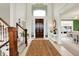 Grand foyer featuring a soaring ceiling, dark wood door, staircase and tiled flooring at 4883 Snowberry Bay Ct, Carmel, IN 46033