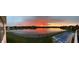 Panoramic view of the lake at sunset with a swimming pool in the foreground at 4883 Snowberry Bay Ct, Carmel, IN 46033