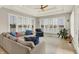 Cozy living room with plantation shutters, lake views, and comfortable sectional sofa at 4883 Snowberry Bay Ct, Carmel, IN 46033
