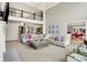 Spacious living room with a soaring ceiling, modern chandelier, and large sectional sofa at 4883 Snowberry Bay Ct, Carmel, IN 46033
