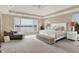 Stunning main bedroom features a lake view, a chaise lounge, and ample natural light at 4883 Snowberry Bay Ct, Carmel, IN 46033