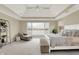 This main bedroom offers scenic water views and a cozy seating area with ample space at 4883 Snowberry Bay Ct, Carmel, IN 46033