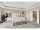 Bright main bedroom with a tray ceiling, large windows, and neutral decor at 4883 Snowberry Bay Ct, Carmel, IN 46033
