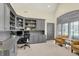 Well-appointed home office with custom built-ins, ample storage, and comfortable seating at 4883 Snowberry Bay Ct, Carmel, IN 46033