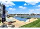 Backyard swimming pool next to a lake with lounge chairs for relaxing in the sun at 4883 Snowberry Bay Ct, Carmel, IN 46033