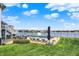 Lakefront pool with lounge chairs offers a serene outdoor experience on a manicured lawn at 4883 Snowberry Bay Ct, Carmel, IN 46033