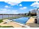 Backyard swimming pool with diving board and view of lake on a sunny day at 4883 Snowberry Bay Ct, Carmel, IN 46033