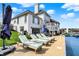 Beautiful backyard with a pool, lawn chairs, and a lake view at 4883 Snowberry Bay Ct, Carmel, IN 46033