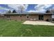 A brick house with a patio and green grass in the backyard at 4912 Cayman Ct, Columbus, IN 47203