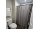Clean bathroom featuring a white toilet and a shower with a neutral curtain providing a functional space at 4912 Cayman Ct, Columbus, IN 47203
