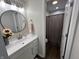 Stylish bathroom featuring modern vanity, round mirror, and shower with contemporary fixtures at 4912 Cayman Ct, Columbus, IN 47203
