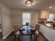 Cozy dining area features a round table, seating for two, and lovely natural light from the window at 4912 Cayman Ct, Columbus, IN 47203