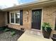 Inviting front entrance with a decorative wreath, potted plant, and a 'Home Sweet Home' doormat at 4912 Cayman Ct, Columbus, IN 47203