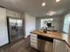 Kitchen with stainless refrigerator, white cabinets, and an open view of the living area at 4912 Cayman Ct, Columbus, IN 47203
