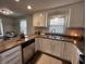 The home boasts a stylish kitchen with stainless appliances, white cabinetry and great light at 4912 Cayman Ct, Columbus, IN 47203