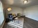 Well-lit living room showcasing a comfortable sofa, accent chair, and a cozy rug on vinyl flooring at 4912 Cayman Ct, Columbus, IN 47203