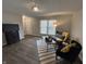 Cozy living room with modern furniture, a striped rug, and plenty of natural light at 4912 Cayman Ct, Columbus, IN 47203