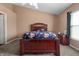 Comfortable bedroom featuring a large window, carpet, and a well-appointed bed with a decorative headboard at 4916 Franklin Villas Dr, Indianapolis, IN 46237