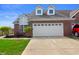 Beautiful home featuring a red brick exterior, white garage door, and well-maintained front yard at 4916 Franklin Villas Dr, Indianapolis, IN 46237
