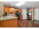 Well-equipped kitchen with stainless steel appliances, wood cabinets, and hardwood floors at 4916 Franklin Villas Dr, Indianapolis, IN 46237