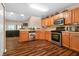 Lovely kitchen featuring wood cabinets, stainless steel appliances, and hardwood floors at 4916 Franklin Villas Dr, Indianapolis, IN 46237