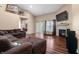 Inviting living room with fireplace, TV, hardwood floors, and access to the backyard at 4916 Franklin Villas Dr, Indianapolis, IN 46237