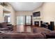 Bright living room with a fireplace, a TV, hardwood floors, and sliding glass doors to the backyard at 4916 Franklin Villas Dr, Indianapolis, IN 46237