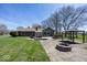 View of the backyard with a brick patio, sunroom, shed, gazebo, and firepit at 506 N County Road 900 E, Avon, IN 46123