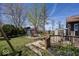 Landscaped backyard featuring a bench swing, shed, and mature trees at 506 N County Road 900 E, Avon, IN 46123