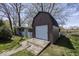 Exterior view of a brown barn in a spacious yard with a white garage door at 506 N County Road 900 E, Avon, IN 46123