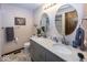Bathroom featuring a double sink vanity, round mirrors, and tile flooring at 506 N County Road 900 E, Avon, IN 46123