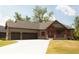 Charming single-story home with a three-car garage and a beautifully landscaped front yard at 5086 Oak Ridge Trl, Columbus, IN 47201