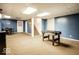 Finished basement area with carpeted floors, featuring a foosball table and bonus room at 516 S 10Th St, Noblesville, IN 46060