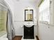 Small bathroom features a pedestal sink, a framed mirror, and a shower and tub combo with a white toilet at 516 S 10Th St, Noblesville, IN 46060
