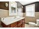 Traditional bathroom with a tiled backsplash, wood vanity, and medicine cabinet at 516 S 10Th St, Noblesville, IN 46060