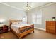 Traditional bedroom featuring carpet floors, a light fixture, and a wooden sleigh bed with side tables at 516 S 10Th St, Noblesville, IN 46060