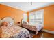 Cozy bedroom featuring hardwood floors and bright, natural light from the window at 516 S 10Th St, Noblesville, IN 46060
