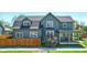 Charming two-story home with a covered porch and a well-maintained front yard and a small fence at 516 S 10Th St, Noblesville, IN 46060