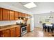 Bright kitchen features stainless steel range, wood cabinets, and a dining area with a black table set at 516 S 10Th St, Noblesville, IN 46060