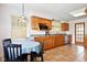 Well-lit kitchen featuring wooden cabinets, granite countertops, and stainless steel appliances at 516 S 10Th St, Noblesville, IN 46060