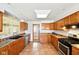 Well-lit kitchen featuring wooden cabinets, granite countertops, and stainless steel appliances at 516 S 10Th St, Noblesville, IN 46060