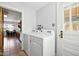 Bright laundry room featuring a side by side washer and dryer and an access door to the outside at 516 S 10Th St, Noblesville, IN 46060