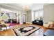 Bright living room with hardwood floors, neutral walls, and a black and light pink detailed rug at 516 S 10Th St, Noblesville, IN 46060