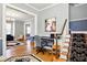 Office featuring a desk and chair, stairs with floral runner, and a view into an adjacent living space at 516 S 10Th St, Noblesville, IN 46060