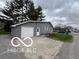 Detached garage with white door and gray siding at 517 Dicks St, Lebanon, IN 46052