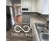 Well-lit kitchen featuring neutral counters, stainless sink, and gray walls at 517 Dicks St, Lebanon, IN 46052
