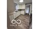 Bright kitchen featuring wood floors, white cabinets, and neutral countertops at 517 Dicks St, Lebanon, IN 46052