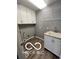 Laundry room featuring gray walls, wood-look floors, sink, and wire shelves at 517 Dicks St, Lebanon, IN 46052