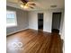 Bright living area with polished wood floors, neutral paint, and classic ceiling fan at 517 Dicks St, Lebanon, IN 46052